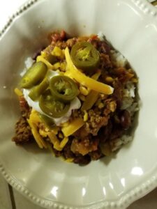 Lowfat Beef Chili topped with Cheddar Cheese and Jalapeno slices