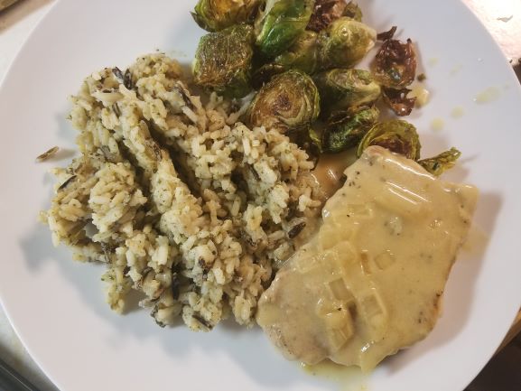 Pork Chops in Mustard Sauce plated with wild rice and roasted brussels sprouts