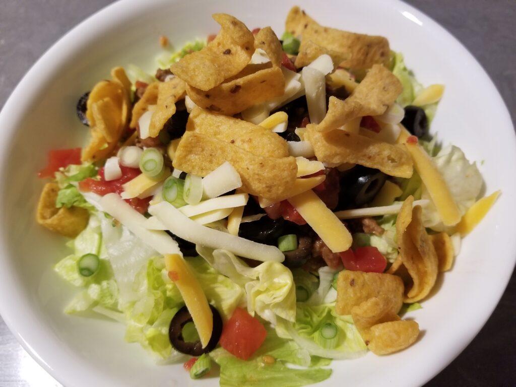 Light Ground Beef Taco Salad served in a white bowl.